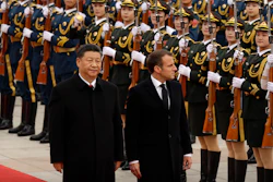 Chinese President Xi Jinping, left, and French President Emmanuel Macron review an honor guard during a welcome ceremony at the Great Hall of the People in Beijing, Nov. 6, 2019.