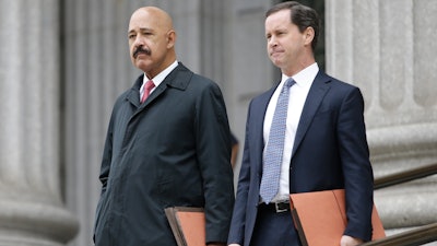 Ted Wells, Jr., left, the lead attorney for Exxon, leaves Manhattan Supreme court with a colleague Nov. 7, 2019.