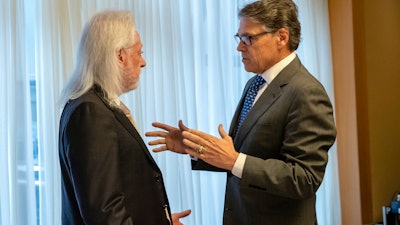 In this Nov. 12, 2018, photo provided by the U.S. Embassy in Kyiv, Energy Secretary Rick Perry talks with Michael Bleyzer.