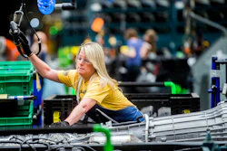 In this June 12, 2019, file photo, General Motors employees work on the chassis line at the Flint Assembly Plant in Flint, Mich.