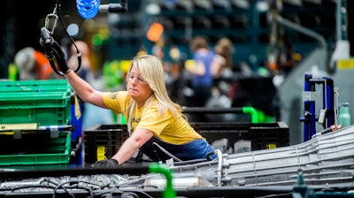 In this June 12, 2019, file photo, General Motors employees work on the chassis line at the Flint Assembly Plant in Flint, Mich.