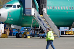 In this April 26, 2019, file photo, a worker walks past a Boeing 737 Max 8 airplane at Boeing's assembly facility in Renton, Wash.