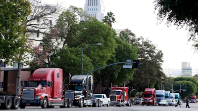 In this Nov. 13, 2009, file photo, a caravan of trucks drive around Los Angeles City Hall during a protest against container fees.