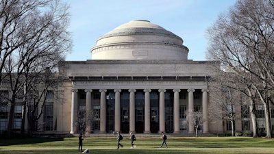 In this April 3, 2017, file photo, students walk past the 'Great Dome' atop Building 10 on the Massachusetts Institute of Technology campus in Cambridge, Mass.