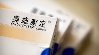 Boxes of OxyContin tablets sold in China sit on a table in Hunan province, Sept. 24, 2019.