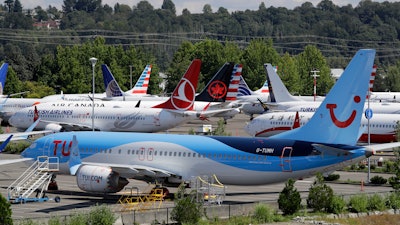 This Aug. 15, 2019, file photo shows dozens of grounded Boeing 737 Max airplanes adjacent to Boeing Field in Seattle.