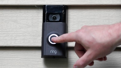 In this July 16, 2019, file photo, Ernie Field pushes the doorbell on his Ring doorbell camera at his home in Wolcott, Conn.