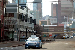 In this Dec. 18, 2018, file photo, one of the test vehicles from Argo AI, Ford's autonomous vehicle unit, navigates through the strip district near the company offices in Pittsburgh.