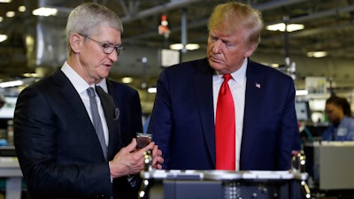 President Donald Trump tours an Apple manufacturing plant, with Apple CEO Tim Cook, Nov. 20, 2019, in Austin.