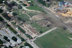 This April 18, 2013, aerial photo shows the remains of a nursing home, left, apartment complex, center, and fertilizer plant, right, destroyed by an explosion at a fertilizer plant in West, Texas.