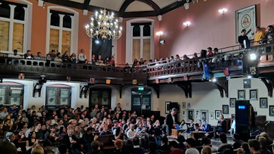 In this Nov. 21, 2019, photo, audience members look on during a debate on the threat of artificial intelligence at the Cambridge Union, the world’s oldest debating society, Cambridge, England.