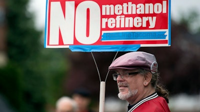 In this 2017 file photo, Mark Keely of Kalama, Wash., stands with other protesters outside the Washington Department of Ecology's Vancouver field office.