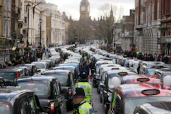 In this Feb. 10, 2016, file photo, taxis block the roads during a protest in central London about unfair competition from ride-sharing services.