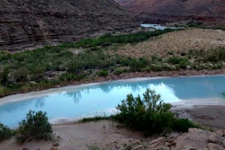 This May 2014 provided by Grand Canyon Trust shows the point where the Little Colorado River and the Colorado River meet in northeastern Arizona.