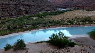 This May 2014 provided by Grand Canyon Trust shows the point where the Little Colorado River and the Colorado River meet in northeastern Arizona.