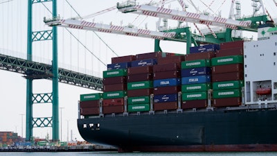 In this June 19, 2019, file photo, a cargo ship is docked at the Port of Los Angeles.