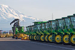 In this Nov. 4, 2019, file photo, John Deere tractors are readied for export to Asia in Tacoma, Wash.