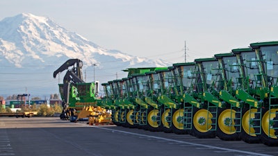 In this Nov. 4, 2019, file photo, John Deere tractors are readied for export to Asia in Tacoma, Wash.