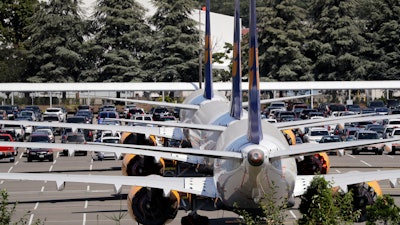 In this Aug. 15, 2019, file photo, three grounded Boeing 737 Max airplanes parked adjacent to Boeing Field in Seattle.