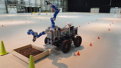 The ANALOG-1 Interact rover located near the European Space Research and Technology Centre in the Netherlands is controlled by a surrogate astronaut based at the European Astronaut Center in Germany. The cones mark out a route that the rover has to follow to get to the sample site.