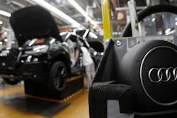 In this March 24, 2018, file photo, part of the assembly line at German car producer Audi plant in Ingolstadt, Germany. The Ingolstadt-based automaker said Tuesday Nov. 26, 2019, that it expected to add 2,000 new positions while Volkswagen subsidiary Audi says it is cutting 9,500 jobs in Germany through 2025.