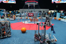In this Friday, Oct. 25, 2019 photo, a team from Cameroon, on the right, compete with Luxembourg during the First Global Challenge, a robotics and artificial intelligence competition in Dubai, United Arab Emirates. Seeking to bolster its image as a forward-looking metropolis, Dubai hosted the largest-ever international robotics contest this week, challenging young people from 190 countries to find solutions to global ocean pollution.