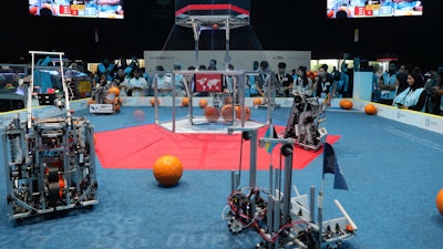 In this Friday, Oct. 25, 2019 photo, a team from Cameroon, on the right, compete with Luxembourg during the First Global Challenge, a robotics and artificial intelligence competition in Dubai, United Arab Emirates. Seeking to bolster its image as a forward-looking metropolis, Dubai hosted the largest-ever international robotics contest this week, challenging young people from 190 countries to find solutions to global ocean pollution.