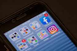 In this Oct. 29, 2019, file photo, a Facebook app is shown on a smartphone in Miami. Facebook said Wednesday, Nov. 13, that it removed 3.2 billion fake accounts from its service from April to September, up slightly from 3 billion in the previous six month.
