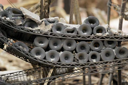 In this Oct. 10, 2017, file photo a rack of burned bottles of wine are seen at a winery in Napa, Calif. The California wildfires are taking a toll on small businesses.