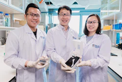 The NUS research team behind the novel algae detection device is led by Assistant Professor Sungwoo Bae (centre) who is holding the smartphone platform. With him are two team members: Mr Si Kuan Thio (left) who is holding the microfluidic chip, and Miss Elaine Chiang (right).