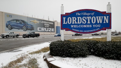 In this Nov. 27, 2018, file photo a banner depicting the Chevrolet Cruze model vehicle is displayed at the General Motors' Lordstown plant in Lordstown, Ohio. General Motors is selling the Ohio assembly plant it closed in March to a new company that plans to begin making electric trucks in late 2020. The company called Lordstown Motors Corp. said Thursday, Nov. 7, 2019, that it initially intends to hire 400 production workers but still needs more money from investors.