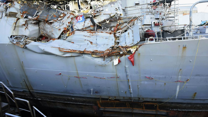 This July 11, 2017, file photo provided by the U.S. Navy shows the USS Fitzgerald in dry dock in Yokosuka, Japan, for repairs and assessment of damage sustained from a June 17 collision with a cargo ship in the waters off of Japan. Survivors and descendants of those killed when a container ship collided with the U.S. Navy destroyer off Japan's coast are suing the ship's Japanese charterer, according to a lawsuit filed Monday, Nov. 18, 2019, that details the survivors' scramble for safety as water rushed in.