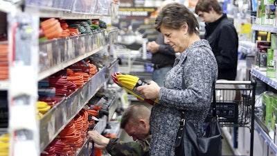 A shopper looks at extension cords at B&C Ace hardware store, Tuesday, Nov. 19, 2019, in Grass Valley, Calif., in preparation of the planned Pacific Gas & Electric power shutdown scheduled for Wednesday and Thursday.