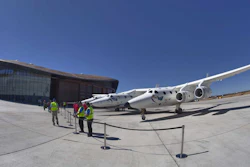 Virgin Galactic's jet-powered carrier aircraft WhiteKnightTwo sits in front of the Spaceport America hangar in Upham, N.M., in 2011.