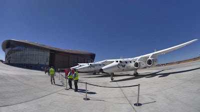 Virgin Galactic's jet-powered carrier aircraft WhiteKnightTwo sits in front of the Spaceport America hangar in Upham, N.M., in 2011.