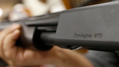 In this March 1, 2018 file photo, the Remington name is seen etched on a model 870 shotgun at Duke's Sport Shop in New Castle, Pa. For years, the gun industry has been immune from most lawsuits, but a recent ruling allowing families of victims in the Newton school shooting to challenge the way an AR-15 used by the shooter was marketed is upending that longstanding roadblock. The U.S. Supreme Court recently rejected efforts by gunmaker Remington to quash the lawsuit, allowing it to continue to be heard in Connecticut courts.