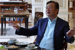 In this Aug. 20, 2019, photo, Huawei's founder Ren Zhengfei gestures as he chats with Huawei executives at the company campus in Shenzhen in Southern China's Guangdong province. Ren says its troubles with President Donald Trump are hardly the biggest crisis he has faced while working his way from rural poverty to the helm of China’s first global tech brand.