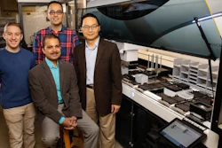 Scott Weisberg, left, professor Saurabh Sinha, seated, Mohammad (Sam) Hamedi Rad and professor Huimin Zhao have combined a fully automated robotic platform with artificial intelligence to develop a new way to manufacture chemicals.