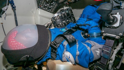 This Nov. 1, 2019 photo provided by Boeing shows Rosie the astronaut test dummy positioned in the space capsule at Kennedy Space Center. The test dummy will be riding to the space station on Boeing’s new Starliner capsule next month, in the first test flight.