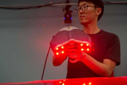 University of Cincinnati aerospace engineering student Yufeng Sun holds a laser scanner used to measure and render objects in three dimensions.