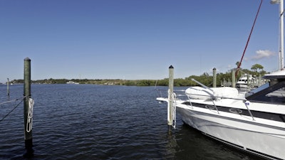 In this Nov. 30, 2017 photo, boats are shown moored in the Anclote River near the old Stauffer chemical plant site in Tarpon Springs, Fla. Hundreds of the nation's most polluted places are at an increasing risk of spreading contamination beyond their borders by more frequent storms and rising seas. Sixty percent of U.S. Superfund sites are in danger from weather extremes like hurricanes or wildfires, and the Trump administration’s reluctance to acknowledge and plan for climate change is hurting chances of safeguarding them, according to a government watchdog.