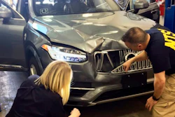 In this March 20, 2018, file photo provided by the National Transportation Safety Board, investigators examine a driverless Uber SUV that fatally struck a woman in Tempe, Ariz.