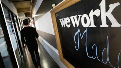 This Nov. 5, 2019 file photo shows a WeWork office space in New York. WeWork says it racked up $1.25 billion in losses in the third quarter as it geared up for an ultimately scuttled stock market debut WeWork’s losses more than doubled between June-September, compared to the same period the previous year, as the office-sharing company spent heavily in pursuit of aggressive growth.