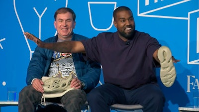 This image taken from video shows Kanye West, right, with Steven Smith, lead designer at Yeezy during a discussion on fashion and design at the Fast Company Innovation Festival in New York on Thursday, Nov. 7, 2019.