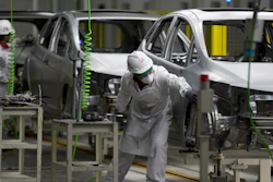 In this Feb. 21, 2014, file photo, employees at work in the new multibillion-dollar Honda car plant in Celaya, in the central Mexican state of Guanajuato.
