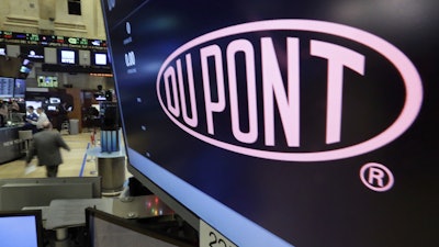 In this Dec. 9, 2015, file photo, the Dupont logo above its trading post on the floor of the New York Stock Exchange.