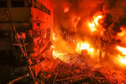 Flames rise from a fire in a densely packed shopping area in Dhaka, Bangladesh, Feb. 21, 2019.