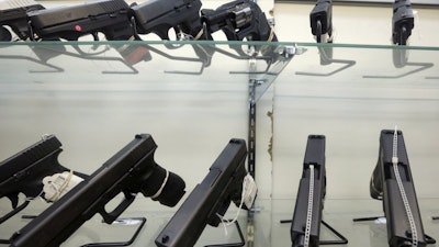 This June 29, 2016, file photo shows guns on display at a gun store in Miami.