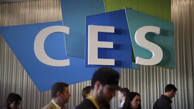 In this Jan. 6, 2017, file photo, attendees walk past the CES sign at CES International in Las Vegas.