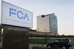 In this May 6, 2014, file photo, a vehicle moves past a sign outside Fiat Chrysler Automobiles world headquarters in Auburn Hills, Mich.